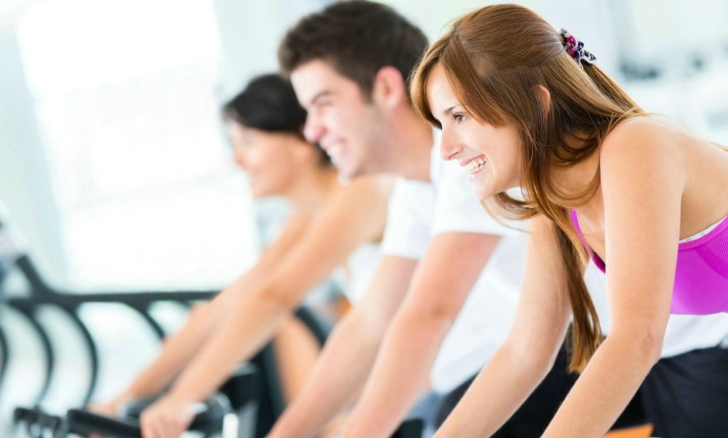 Group of people at the gym doing spinning